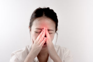 woman has a pain in nose or sinusitis (sinus infection)